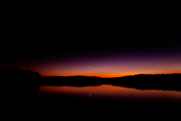 The last visible light of sunset as the stars become visible as well over the Falls Lake Reservoir in Raleigh, North Carolina.