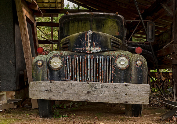 A vintage Ford truck found parked in barn alongside a rural North Carolina highway. I just loved the old wood bumper someone put on it.