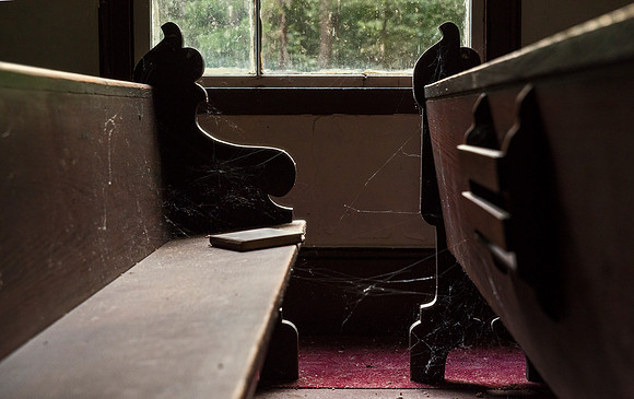 A not quite abandoned chapel in rural eastern North Carolina. The chapel is being cared for but not restored and is apparently never used. The hymnals inside seemed strange.