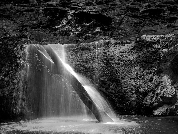At Natural Bridge in Springbrook National Forest, not far from Brisbane Australia. A river tumbles through the roof of cave.