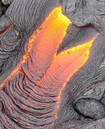 Pahoehoe lava flows from Pu'u O'o crater on Kilauea Volcano's southeast rift zone. Taken overhead from a helicopter. This image resembles a formal gown.