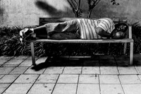 A homeless man claiming a bench for the night in downtown Raleigh.