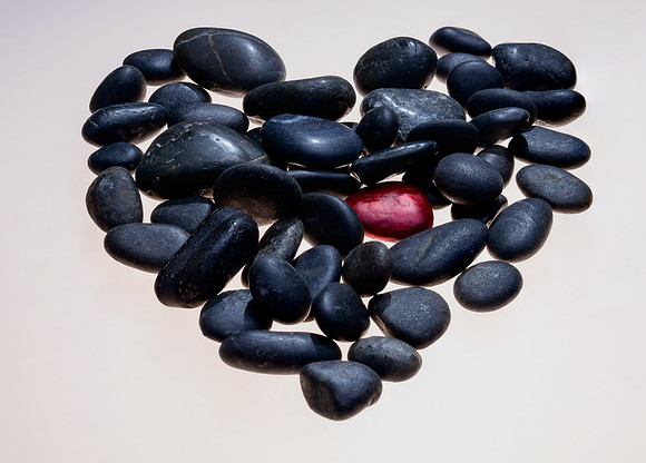 Conceptual photo. The original idea was to photograph the one red rock mixed in with the other black ones, when I laid the rocks out they naturally took a shape that resembled a heart so that gave me
