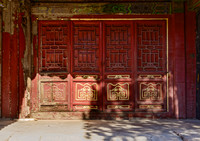 Original wooden doors still with gold leaf at the Forbidden City in Beijing, China.