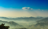 Looking out over a valley below the Great Wall of China.
