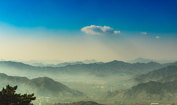 Looking out over a valley below the Great Wall of China.